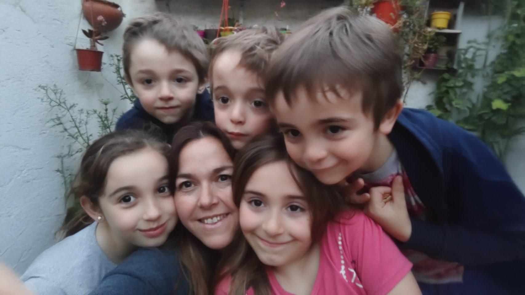 Maria as she is taking a selfie with her five children.